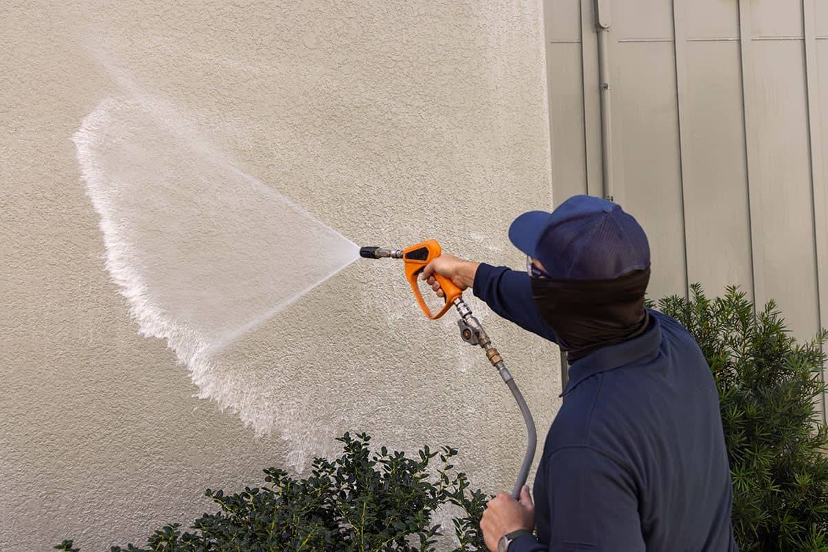pressure washing professional professional washing siding of home with sprayer